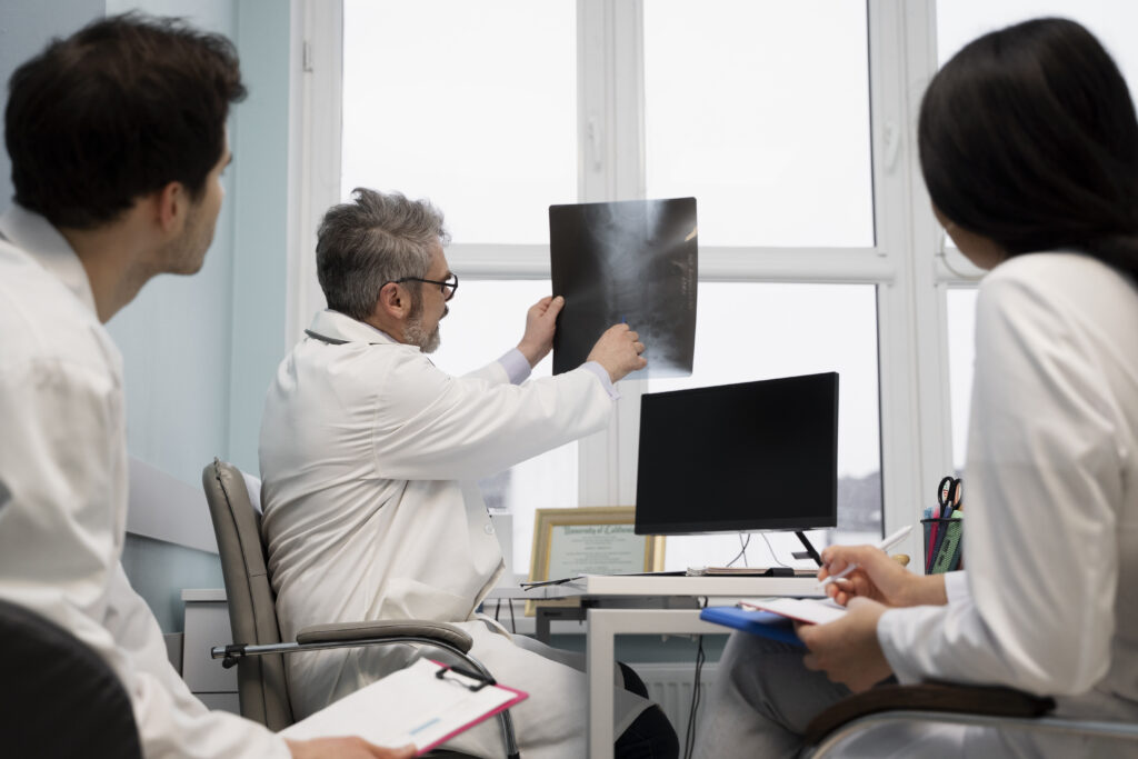 medium shot doctors looking radiography